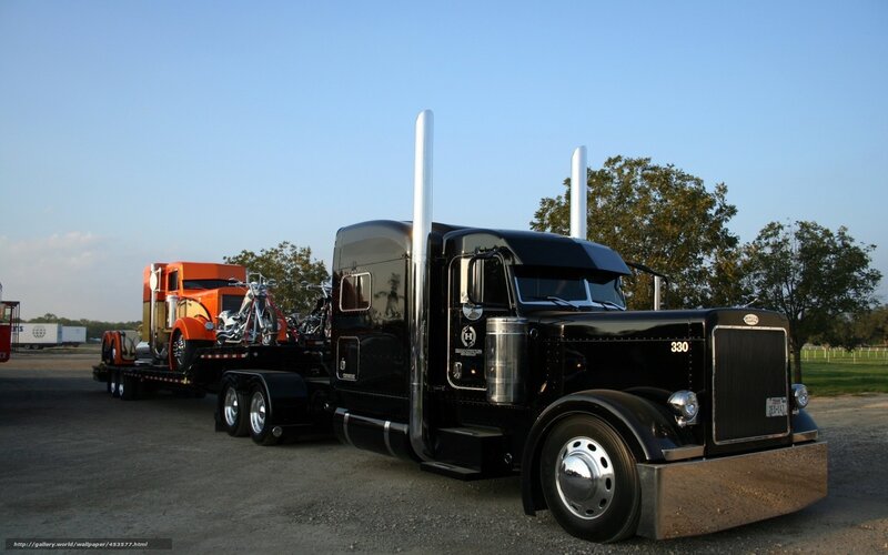 Black Peterbilt truck with trailer