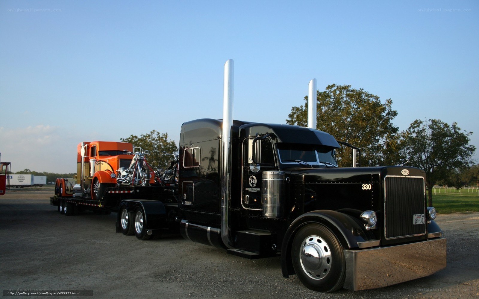 Black Peterbilt truck with trailer