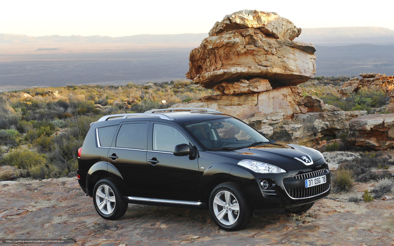 Black Peugeot 4007 in desert