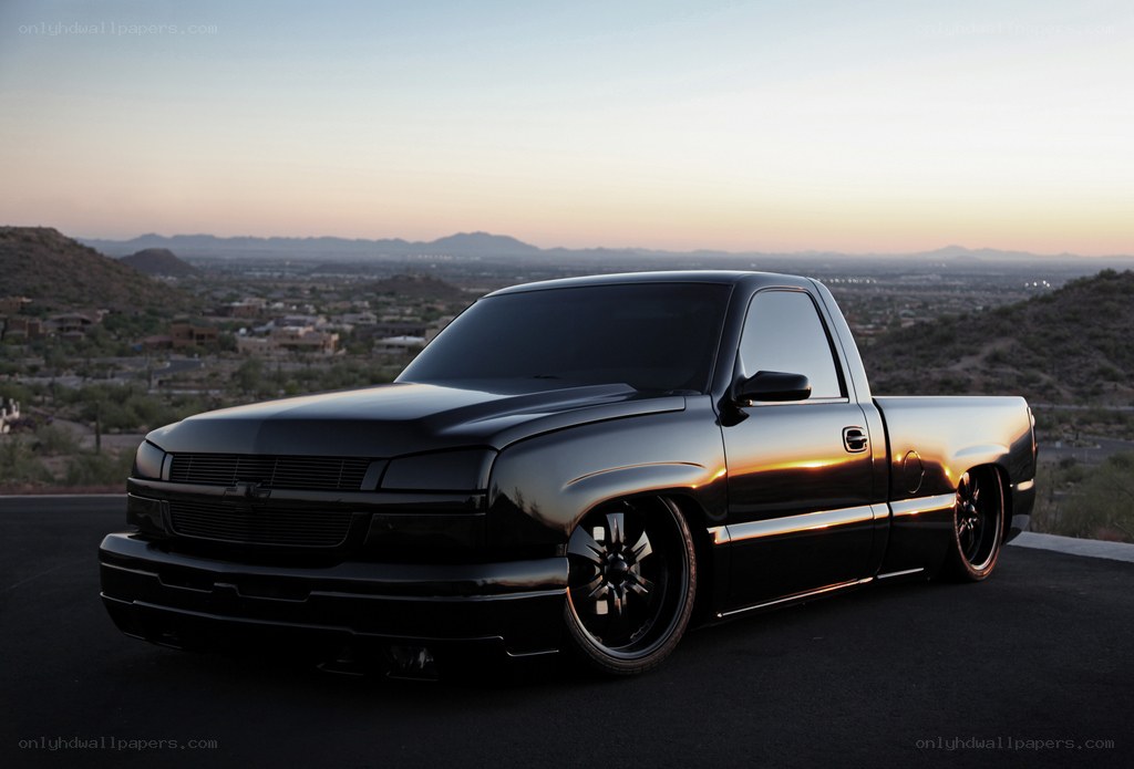 black pickup truck at sunset