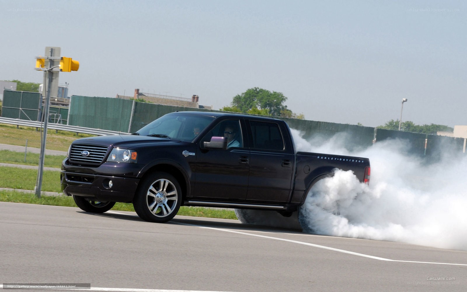 black pickup truck doing burnout