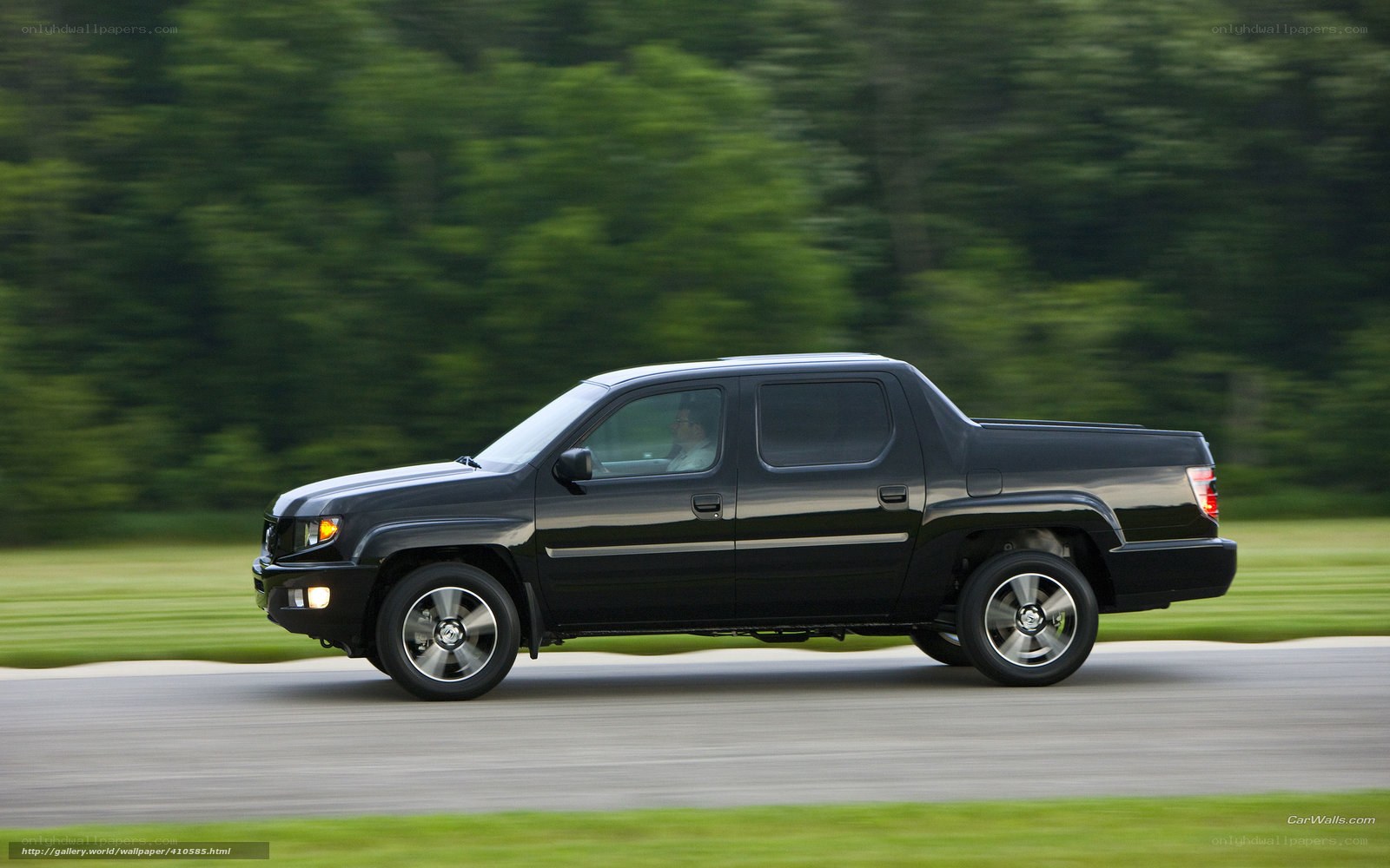 Black pickup truck in motion