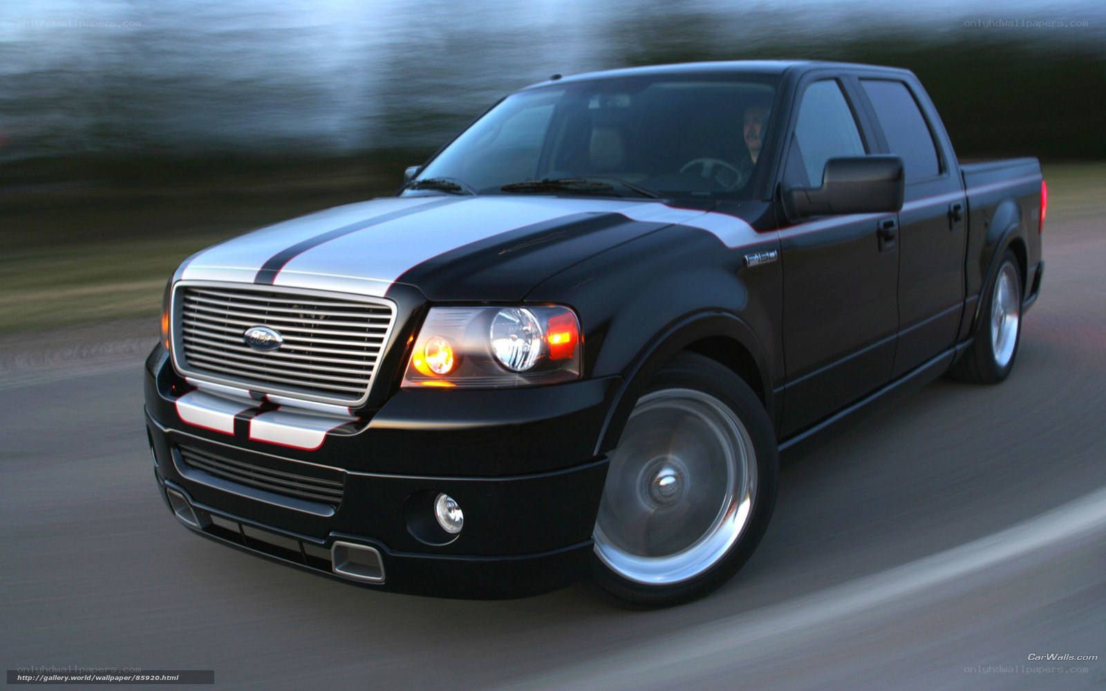 black pickup truck in motion