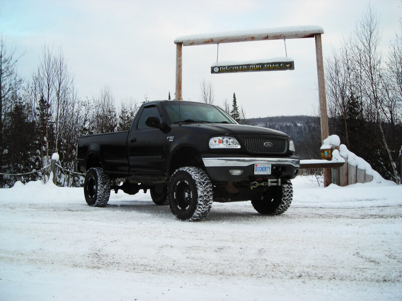 Black pickup truck in snowy landscape