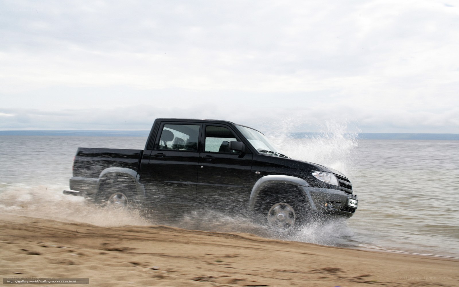 black pickup truck on beach