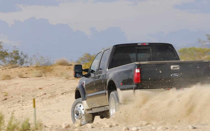 black pickup truck on dirt road