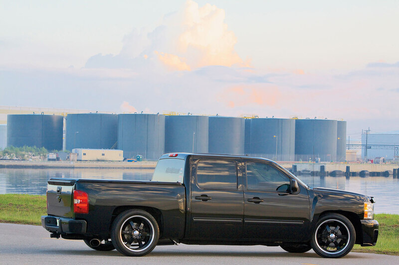 Black Pickup Truck — Serene, Sunset, Photograph, Storage Tanks