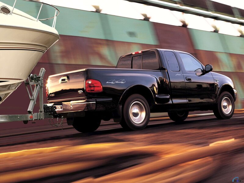 Black pickup truck towing boat