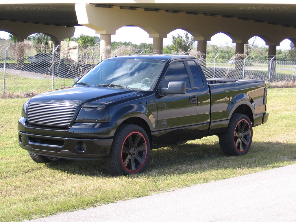black pickup truck under overpass
