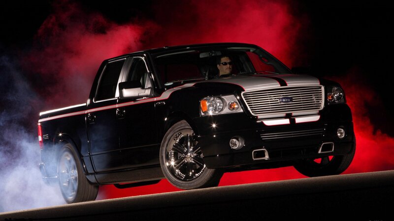 black pickup truck with red smoke