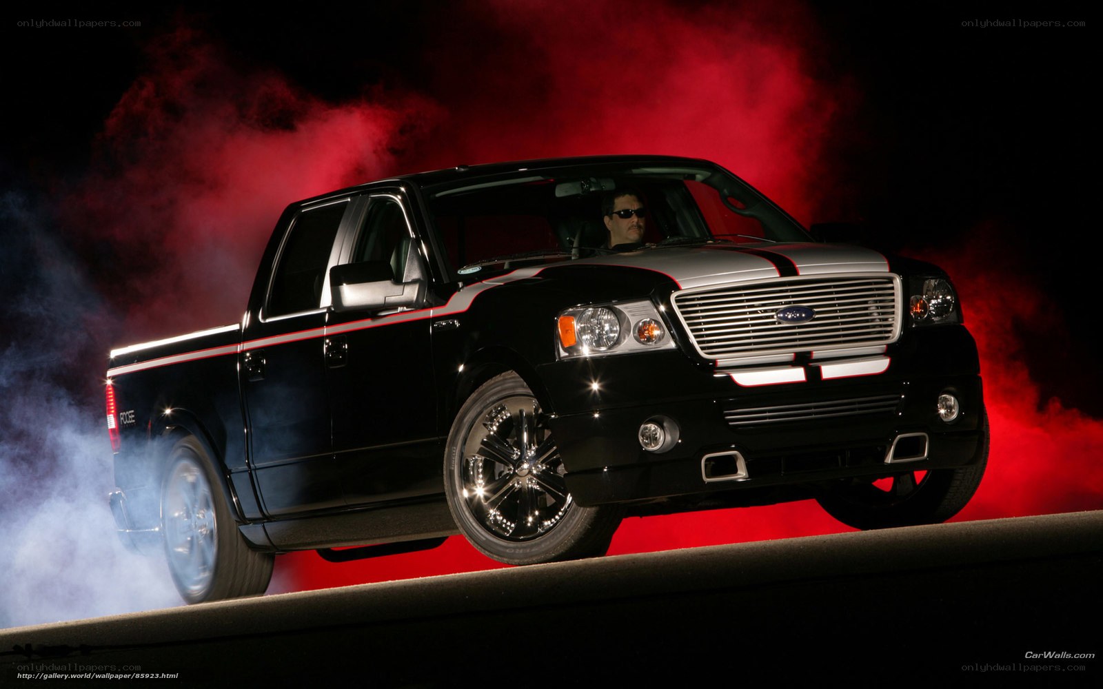 black pickup truck with red smoke