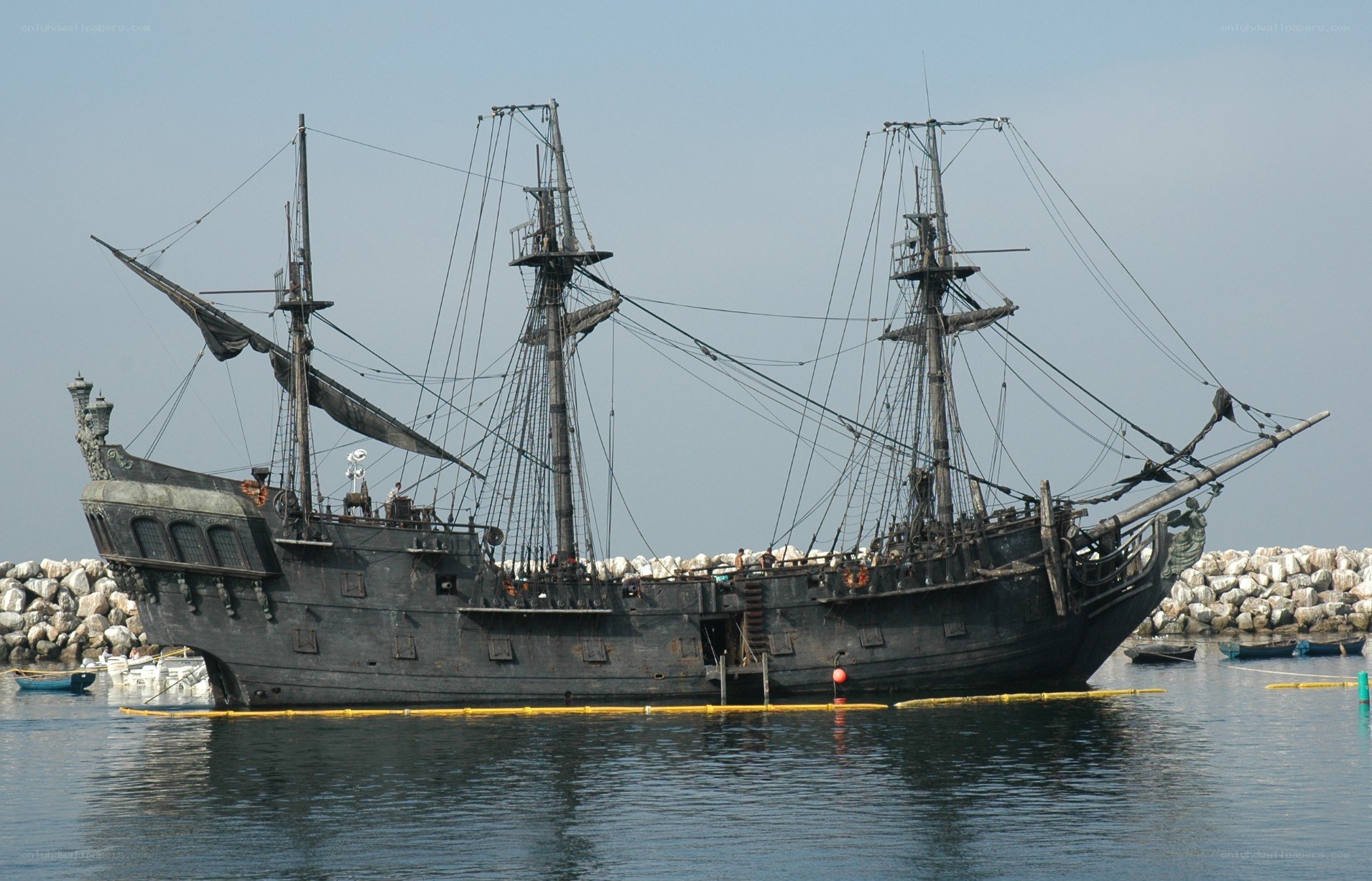 Black pirate ship in harbor