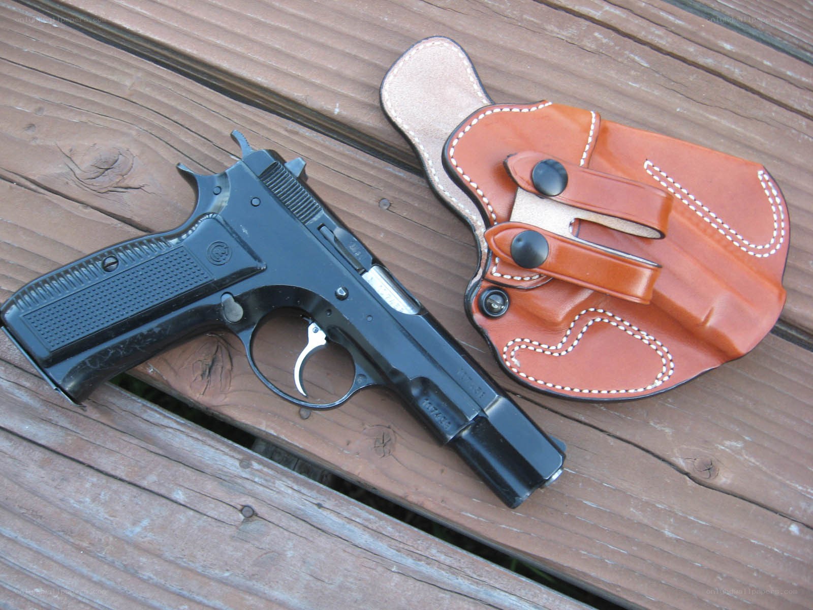 black pistol and leather holster