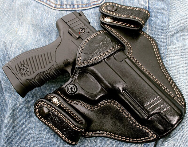 black pistol in leather holster
