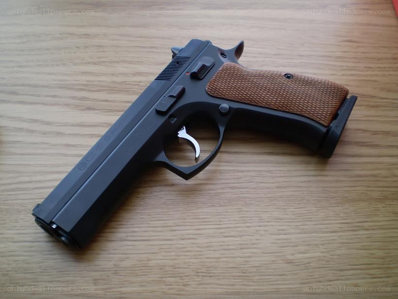black pistol with brown grip
