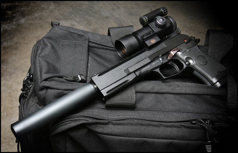 Black pistol with scope and suppressor
