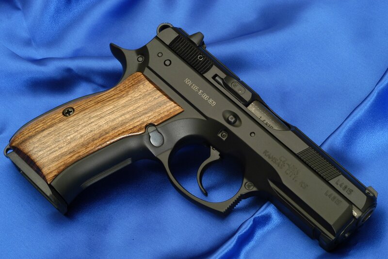 black pistol with wooden grip