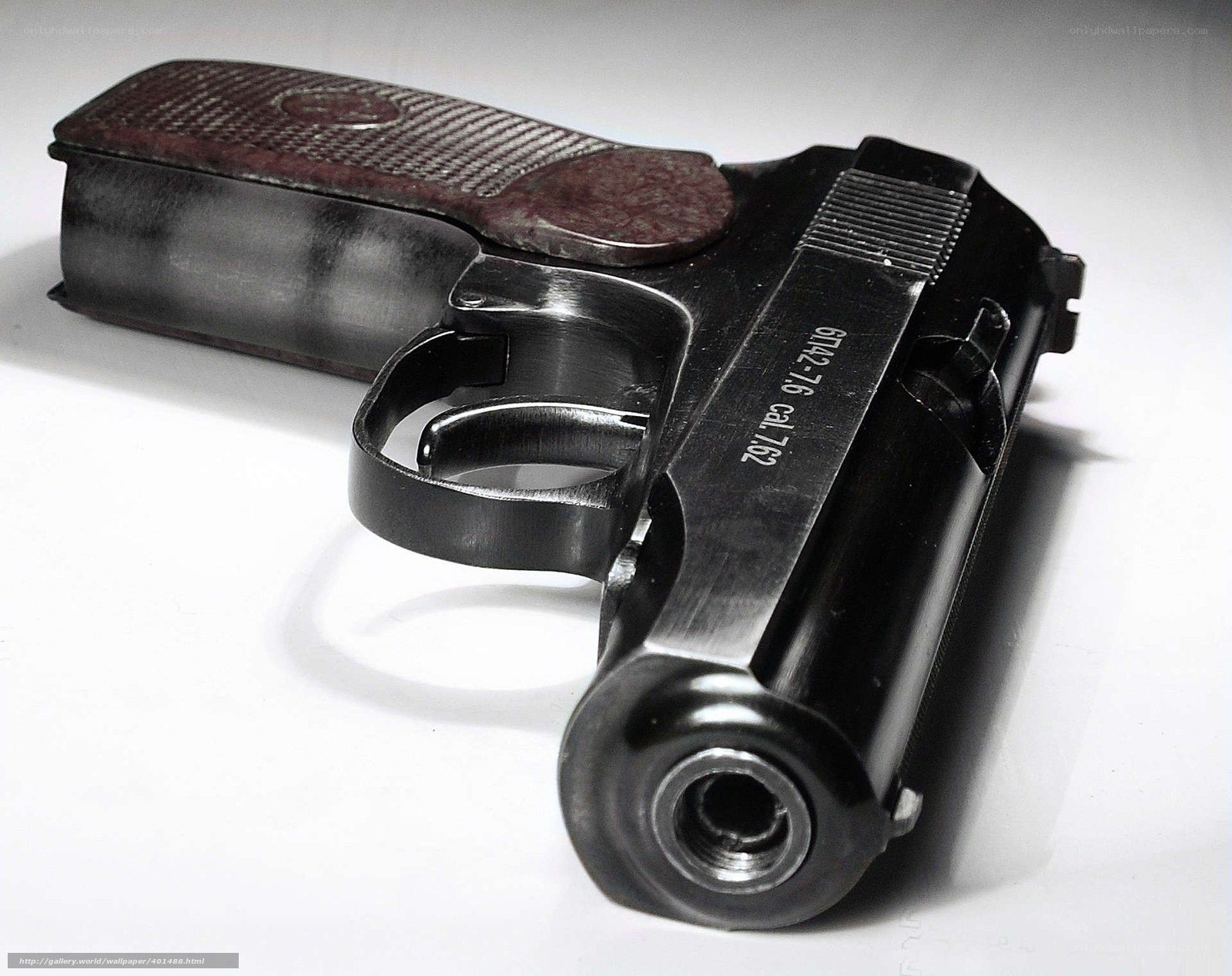 black pistol with wooden grip
