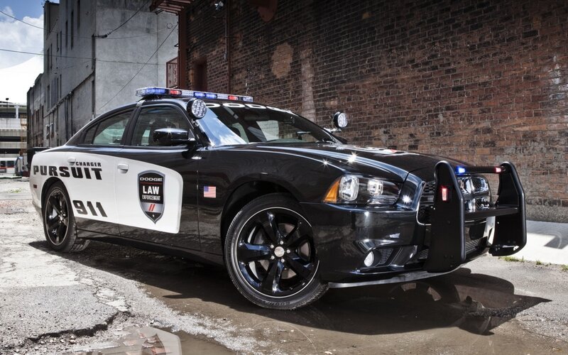 Black Police Car — Dramatic, Afternoon, Photograph, Brick Wall, Light Bar, Bumper Guard