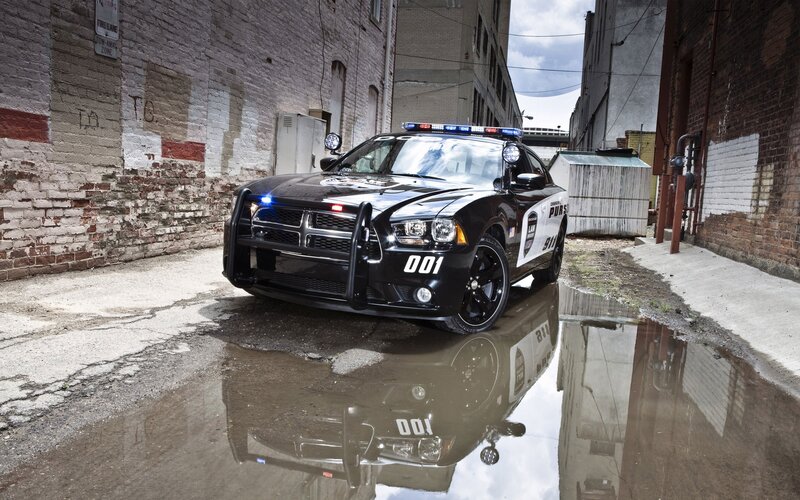 Black Police Car — Dramatic, Afternoon, Photograph, Brick Wall, Puddle