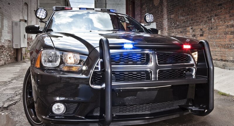 Black Police Car — Dramatic, Afternoon, Photograph, Bricks