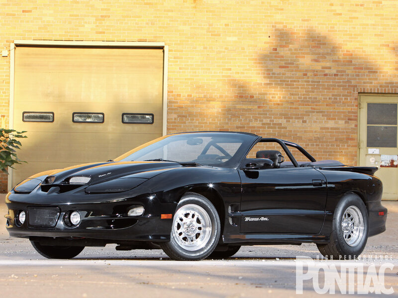 Black Pontiac Firebird — Calm, Afternoon, Photograph, Brick Wall