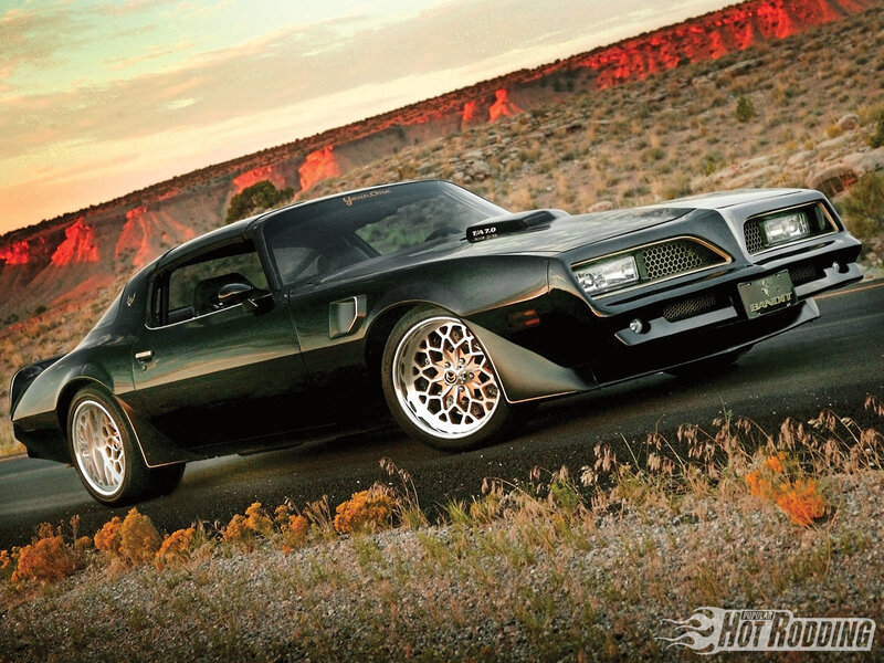 Black Pontiac Firebird on desert road