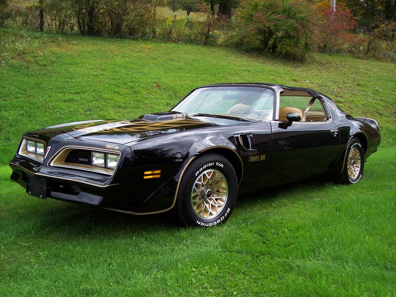 Black Pontiac Trans Am on grass