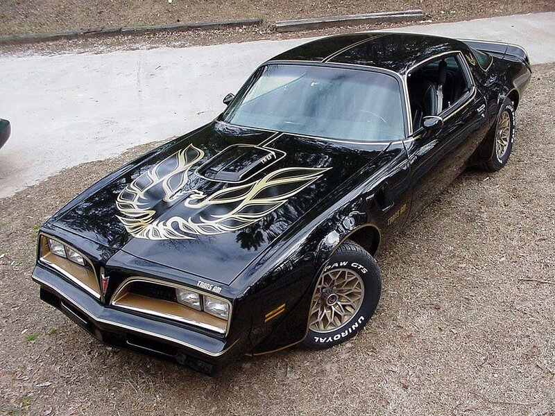 Black Pontiac Trans Am with gold flames