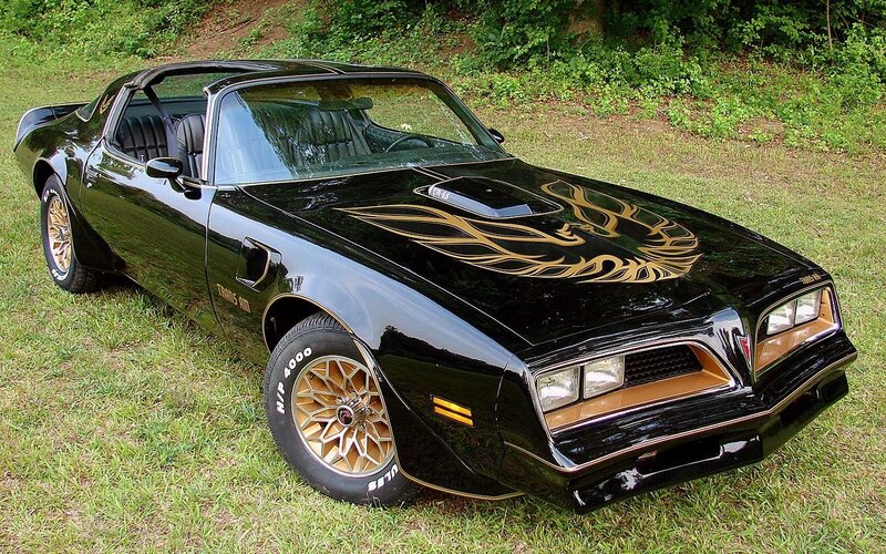 Black Pontiac Trans Am with gold flames