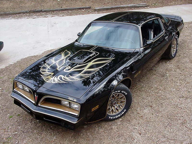 Black Pontiac Trans Am with gold flames