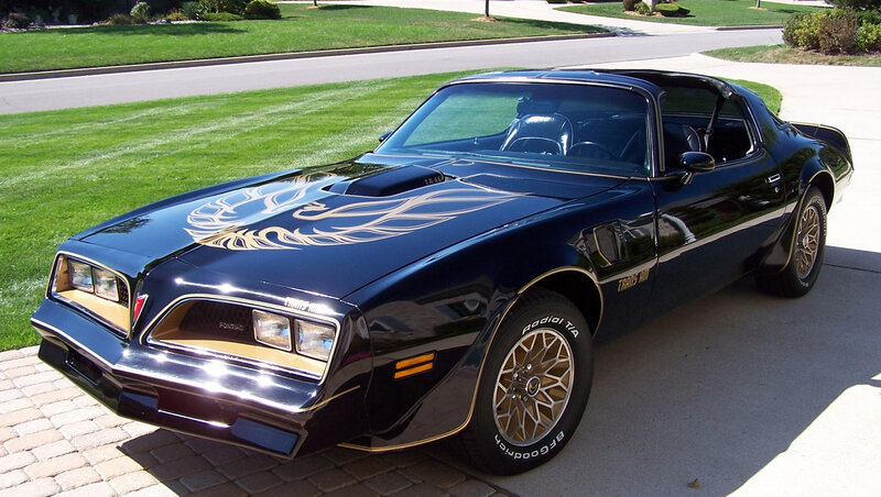 Black Pontiac Trans Am with gold flames