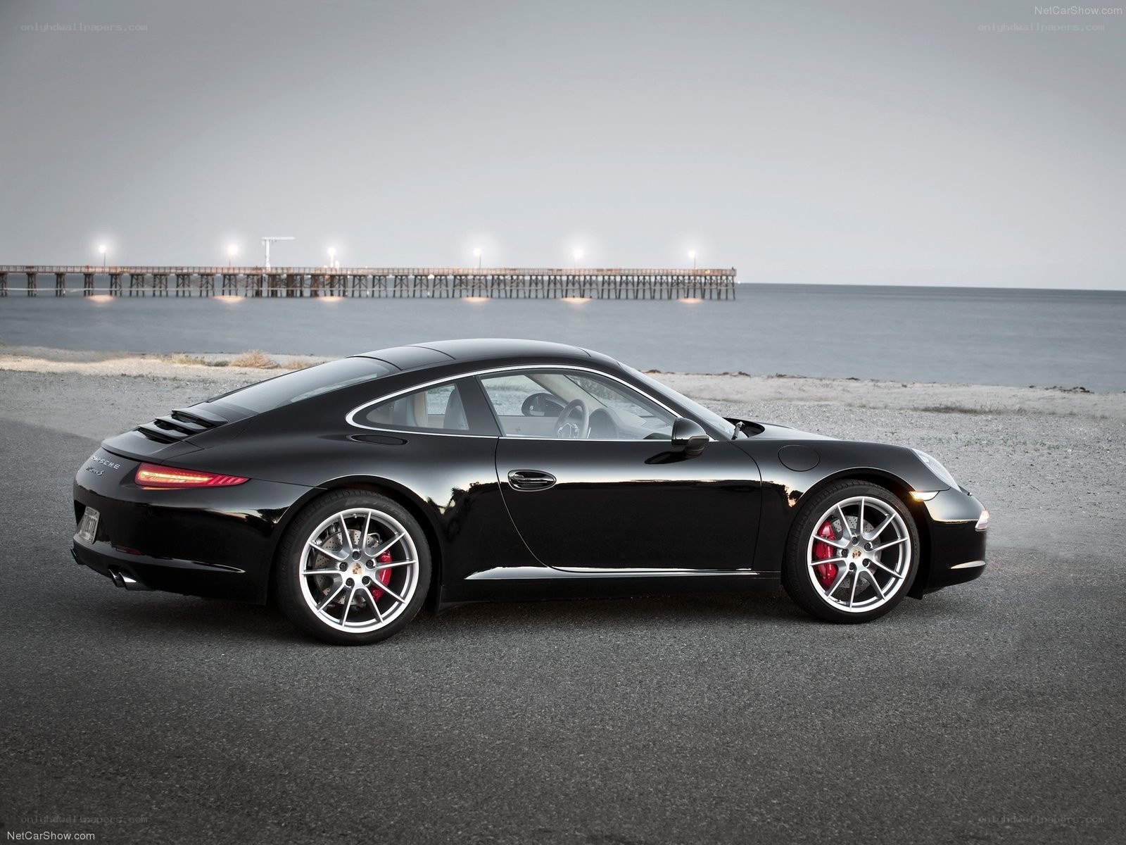 Black Porsche 911 on a beach
