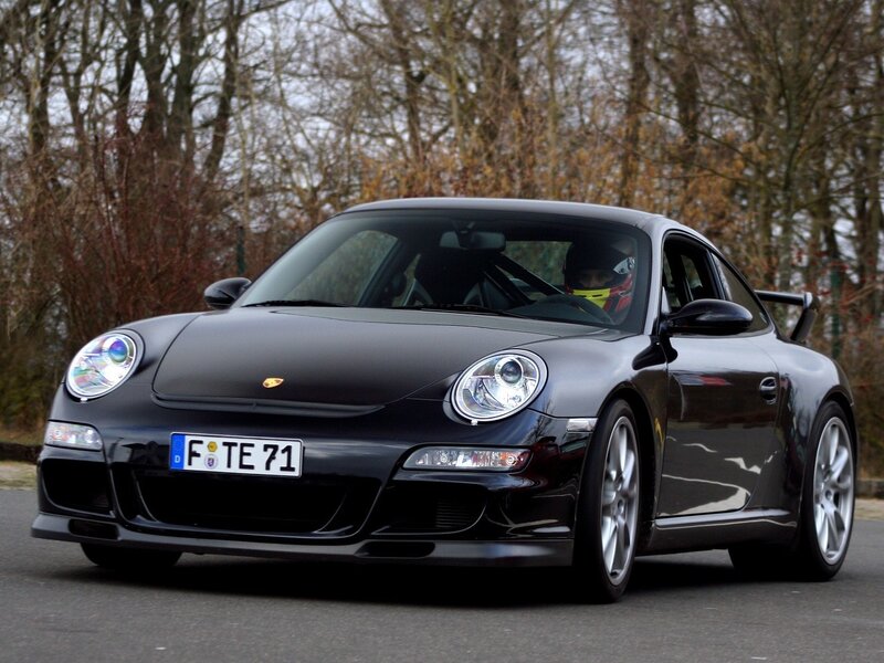 Black Porsche 911 on a road
