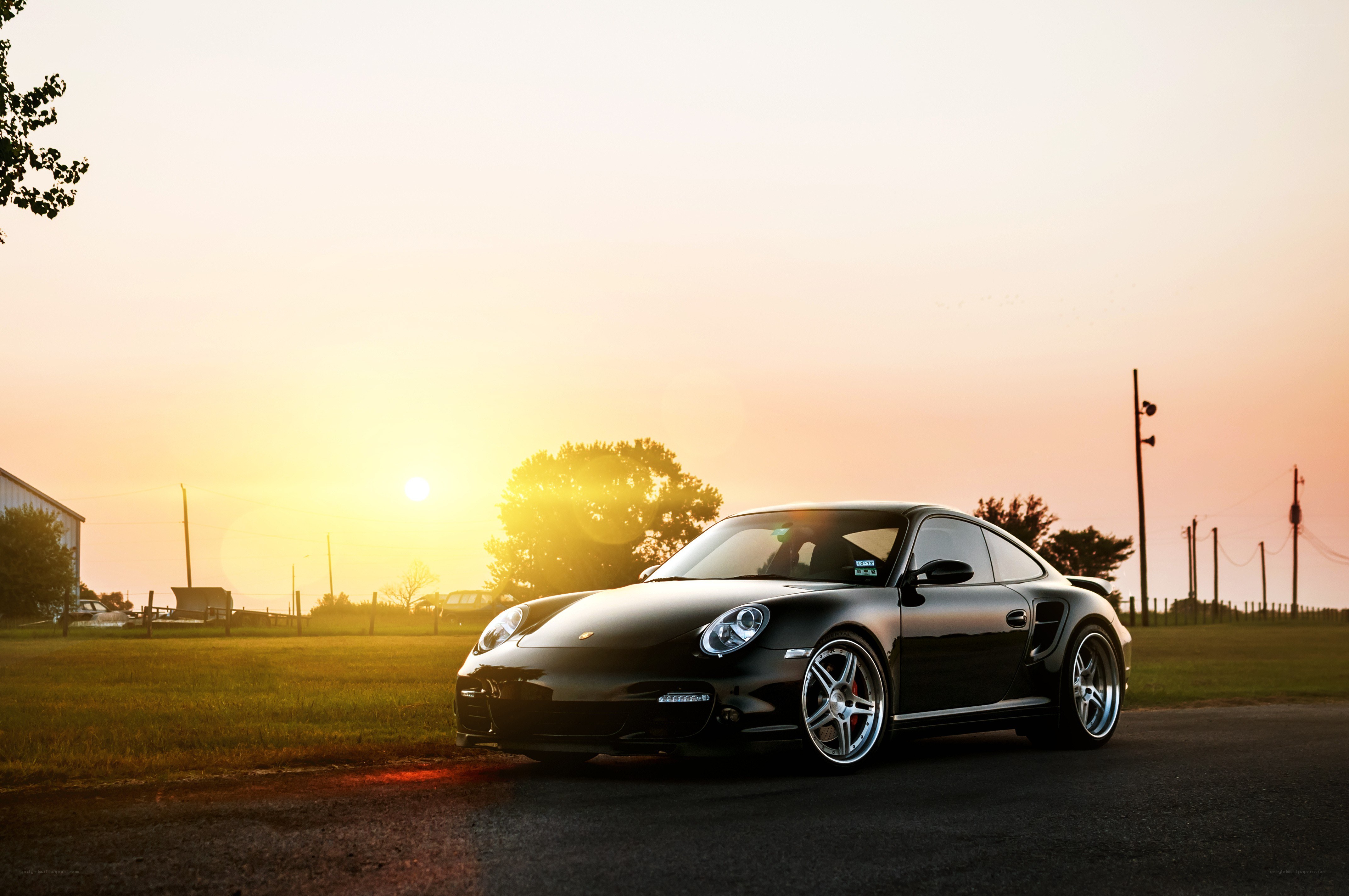 Black Porsche at sunset
