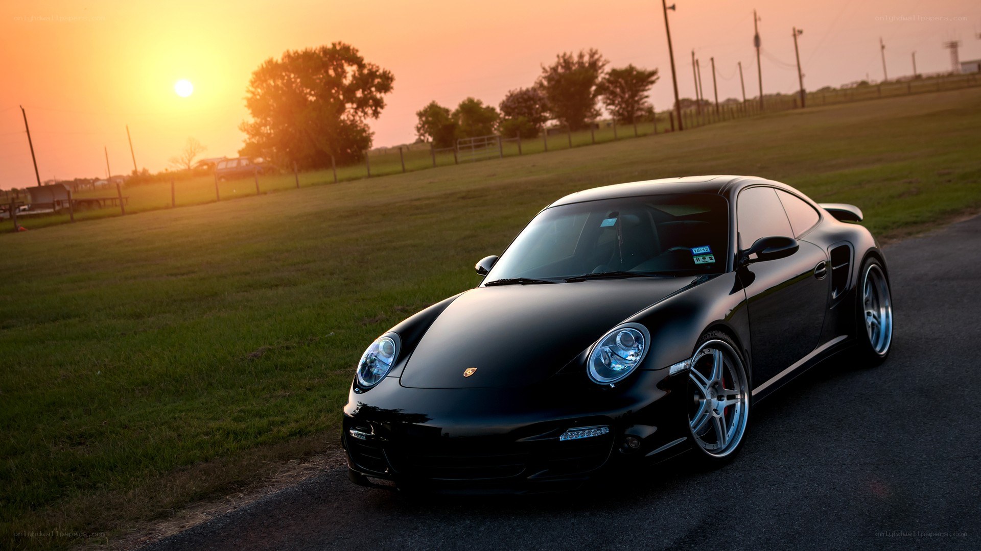 Black Porsche at sunset