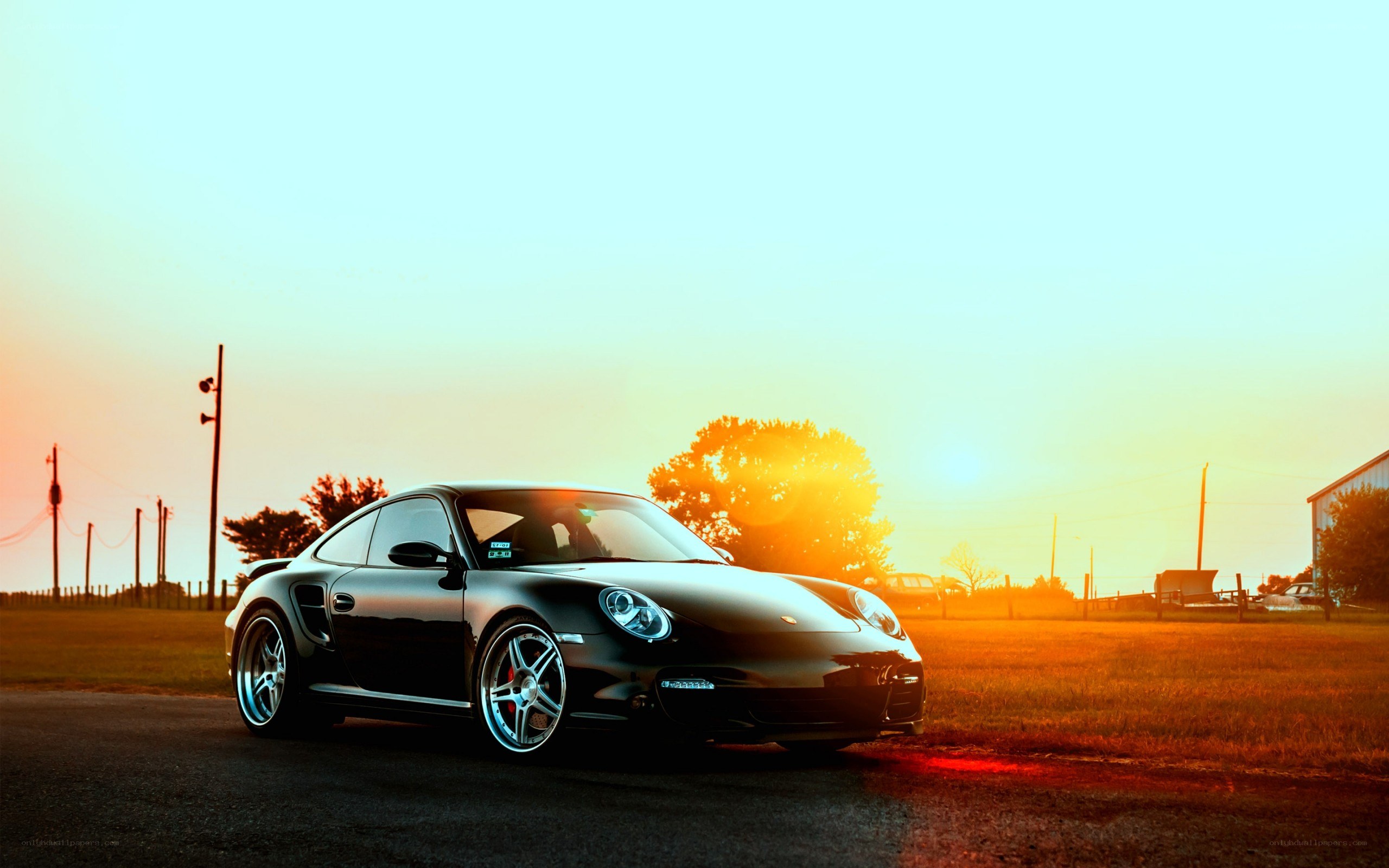Black Porsche at sunset