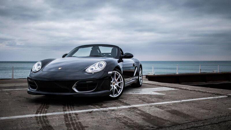 Black Porsche Boxster by the sea