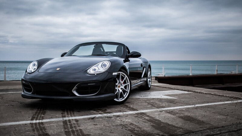 Black Porsche Boxster by the sea