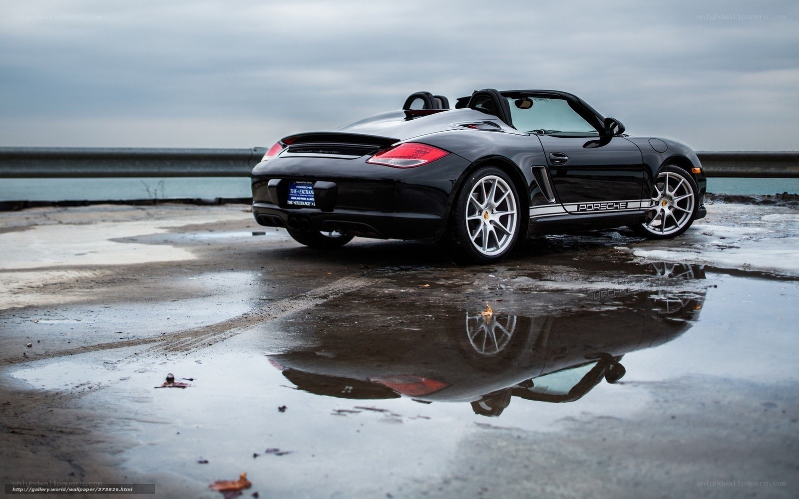 Black Porsche Boxster by water