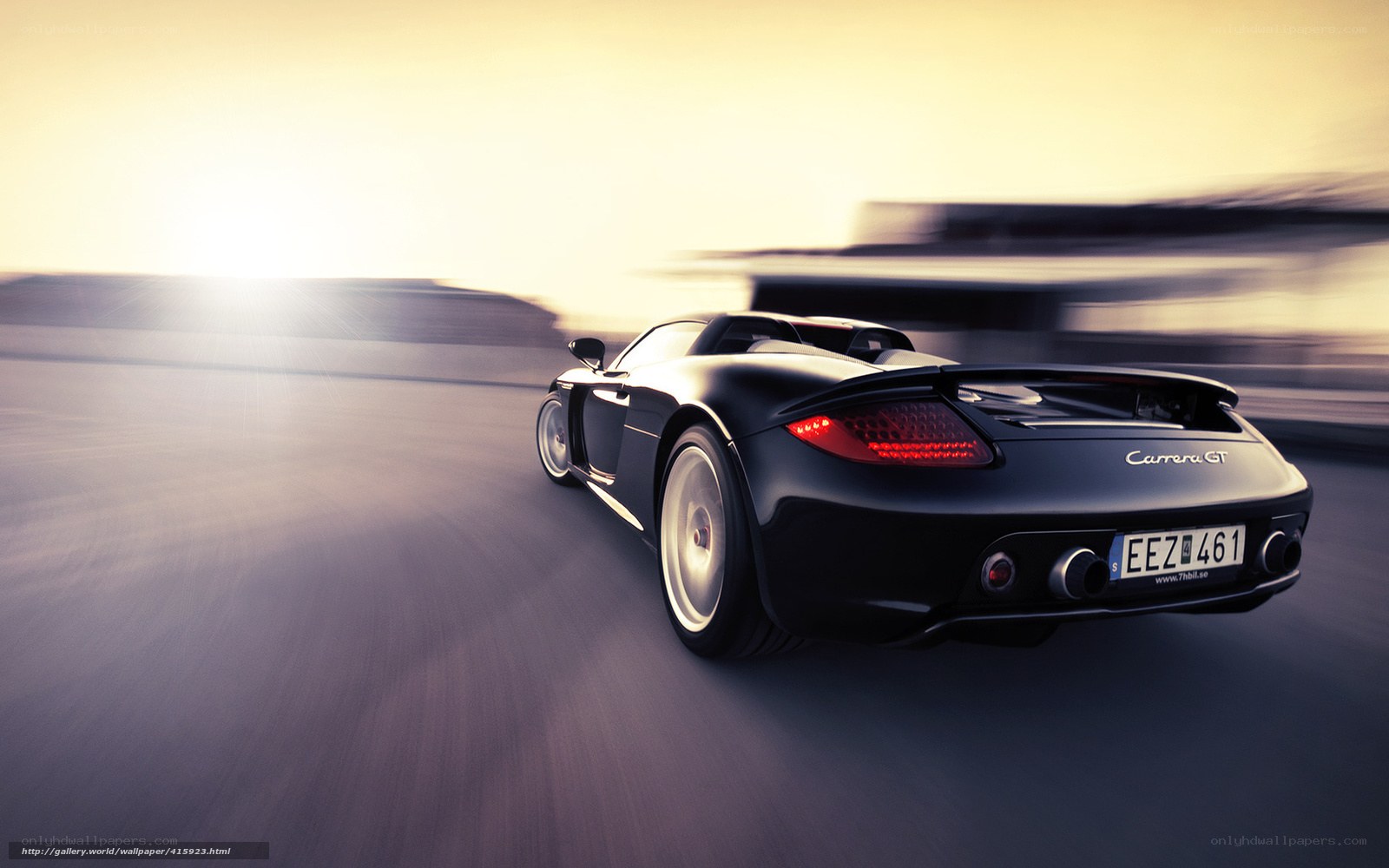 Black Porsche Carrera GT in motion