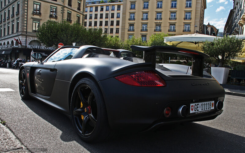 Black Porsche Carrera GT on city street