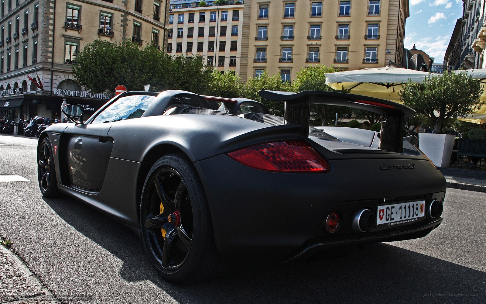 Black Porsche Carrera GT on city street