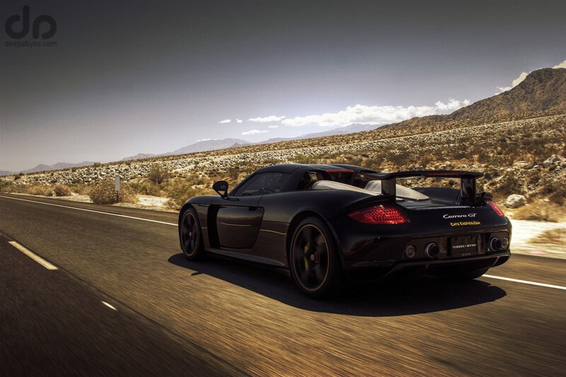Black Porsche Carrera GT on desert road