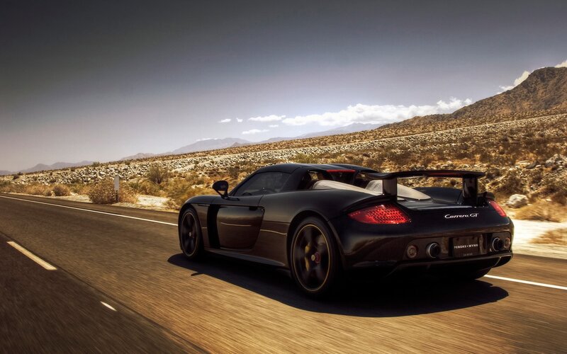 Black Porsche Carrera GT on desert road