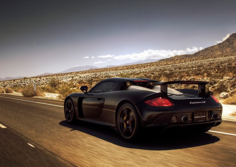 Black Porsche Carrera GT on desert road