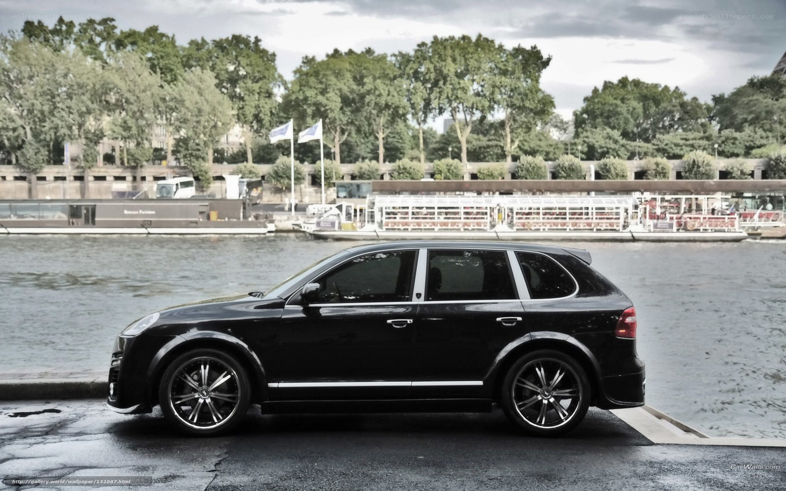 Black Porsche Cayenne by river