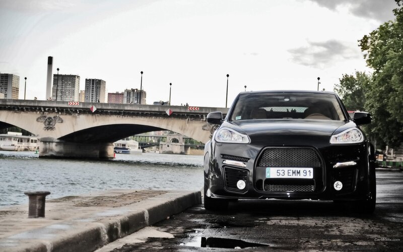 Black Porsche Cayenne by the river