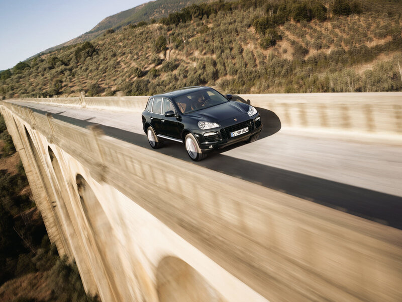 Black Porsche Cayenne on a bridge