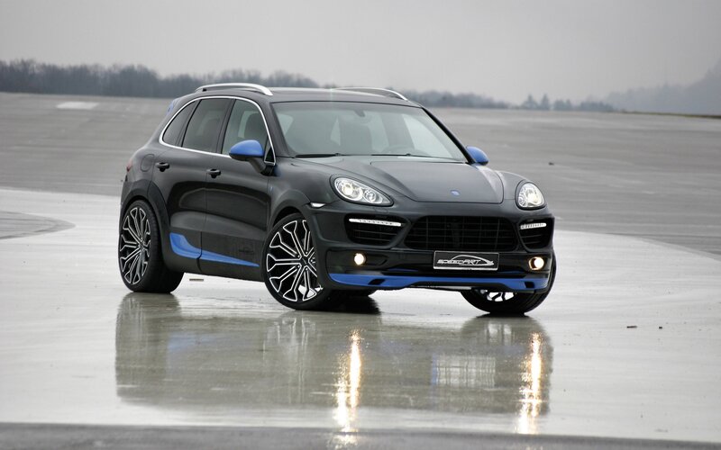 black porsche cayenne on wet tarmac